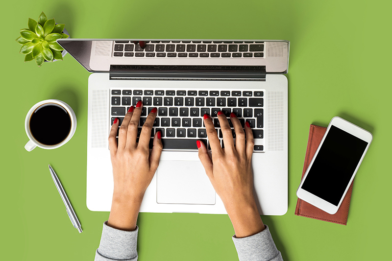 Customer Portal Image for the Cosmetic Solutions Customer Portal. The Image features two hands working on a laptop computer.